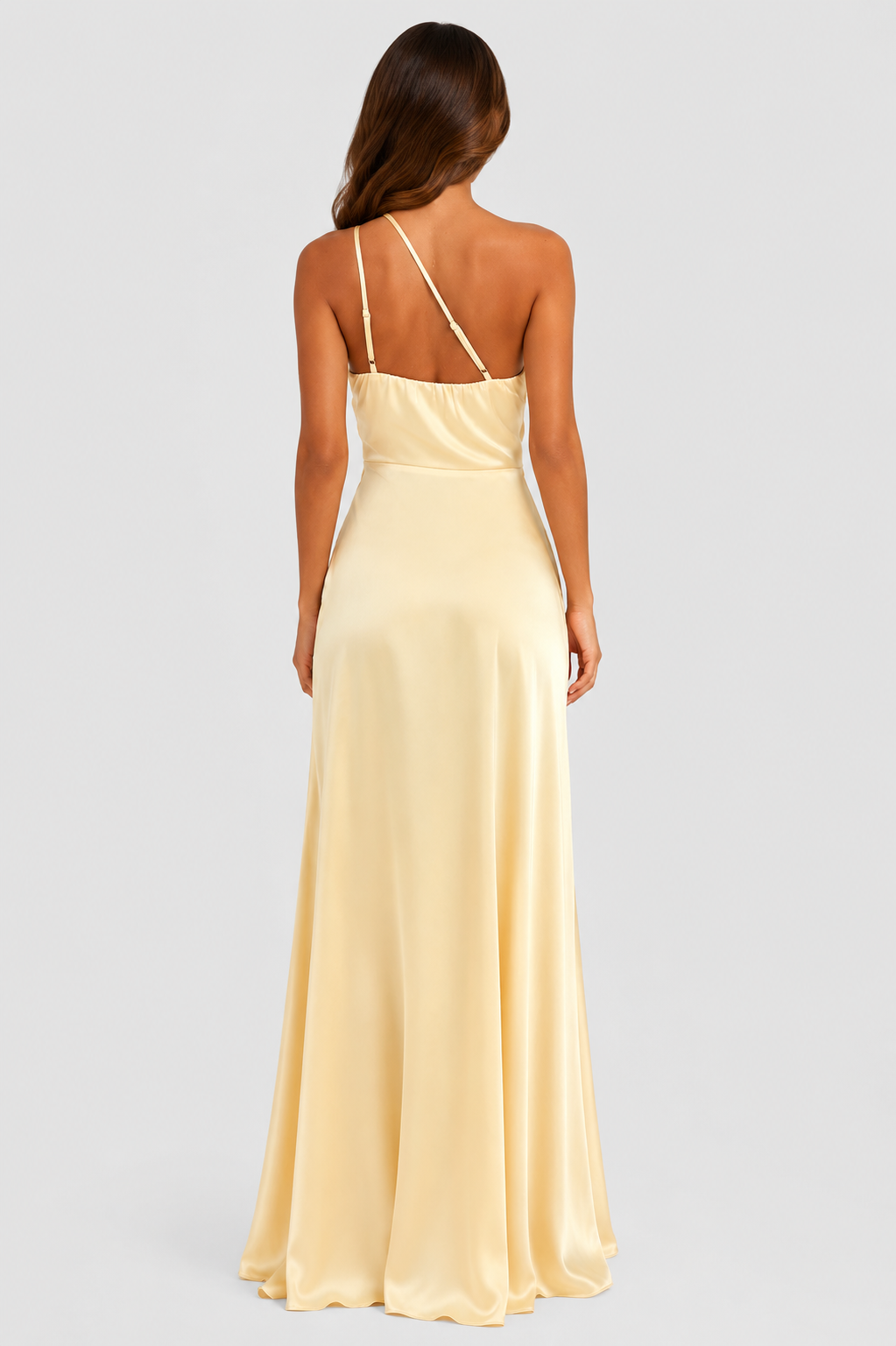 Woman wearing a soft beige asymmetric maxi dress with a one-shoulder neckline, fitted bodice, elegant draped silhouette and thigh-high side split, styled for weddings, evening events and formal occasions.