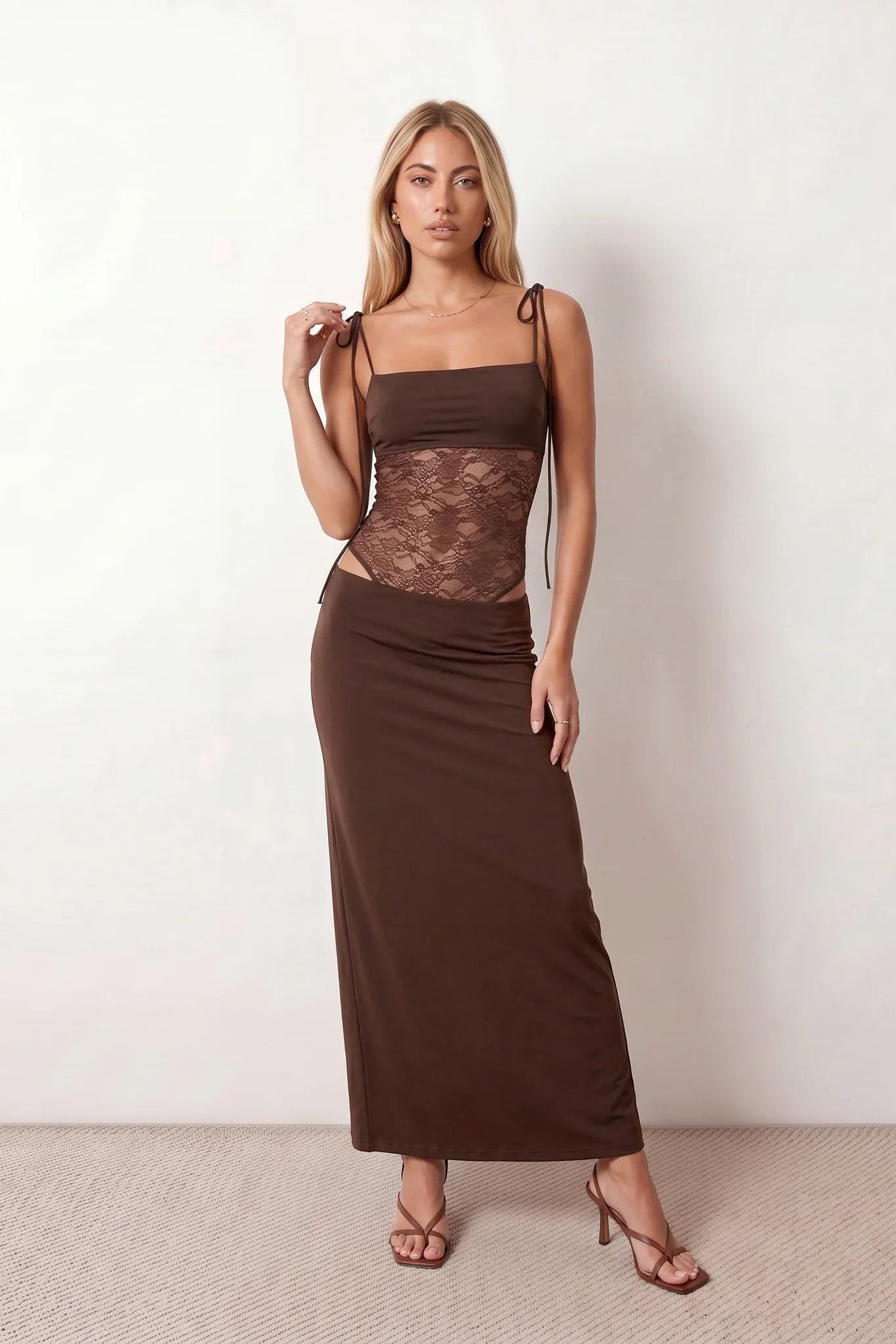 Women’s lace panel maxi dress featuring a square neckline, adjustable spaghetti straps, sheer lace waist, low open back, and floor-length silhouette for evening wear.