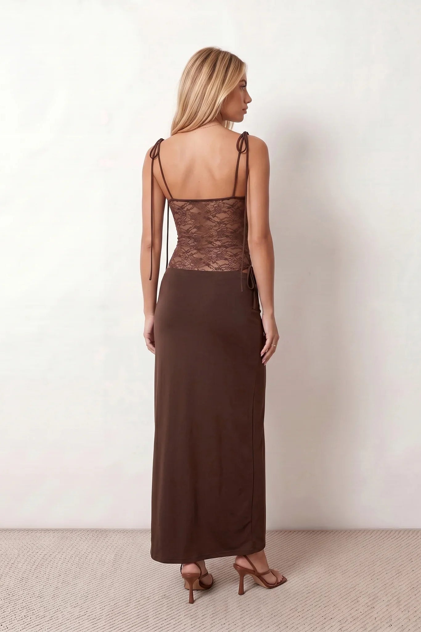 Women’s lace panel maxi dress featuring a square neckline, adjustable spaghetti straps, sheer lace waist, low open back, and floor-length silhouette for evening wear.