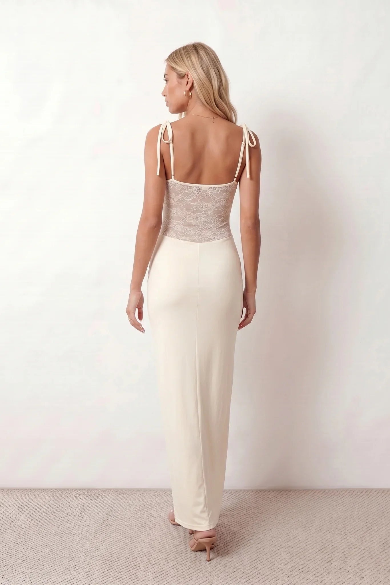 Women’s lace panel maxi dress featuring a square neckline, adjustable spaghetti straps, sheer lace waist, low open back, and floor-length silhouette for evening wear.