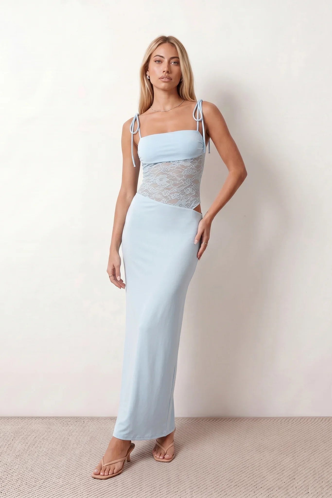 Women’s lace panel maxi dress featuring a square neckline, adjustable spaghetti straps, sheer lace waist, low open back, and floor-length silhouette for evening wear.