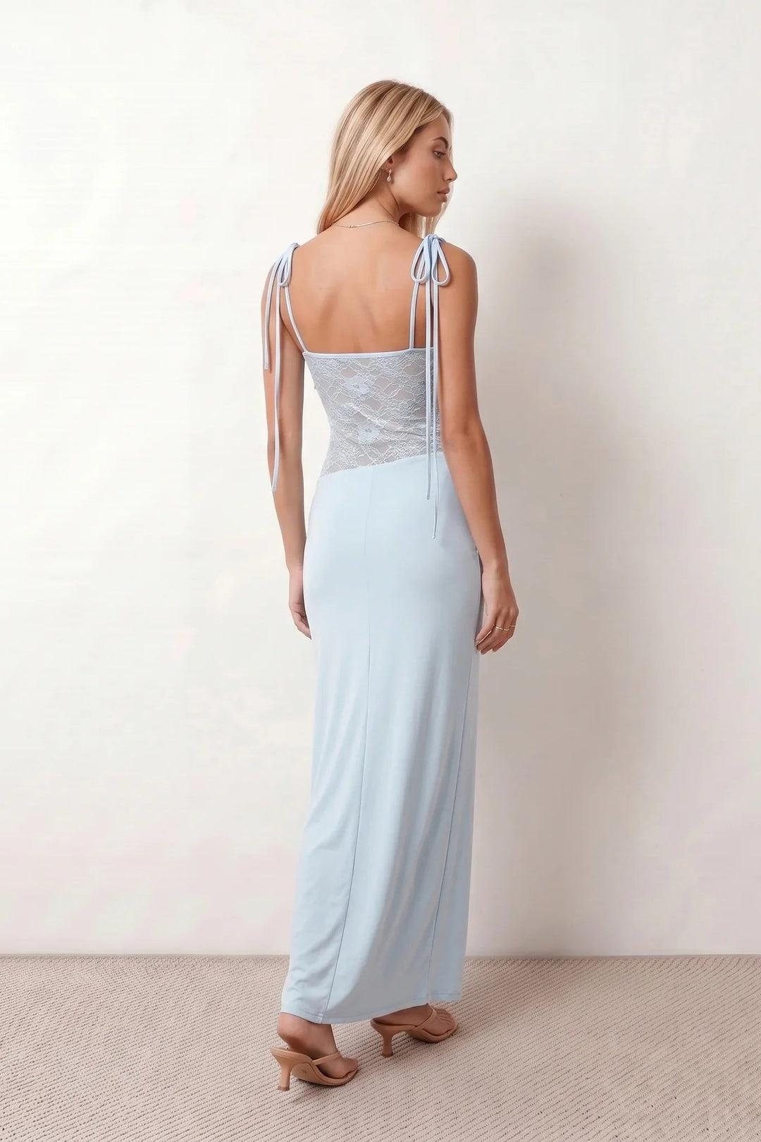 Women’s lace panel maxi dress featuring a square neckline, adjustable spaghetti straps, sheer lace waist, low open back, and floor-length silhouette for evening wear.