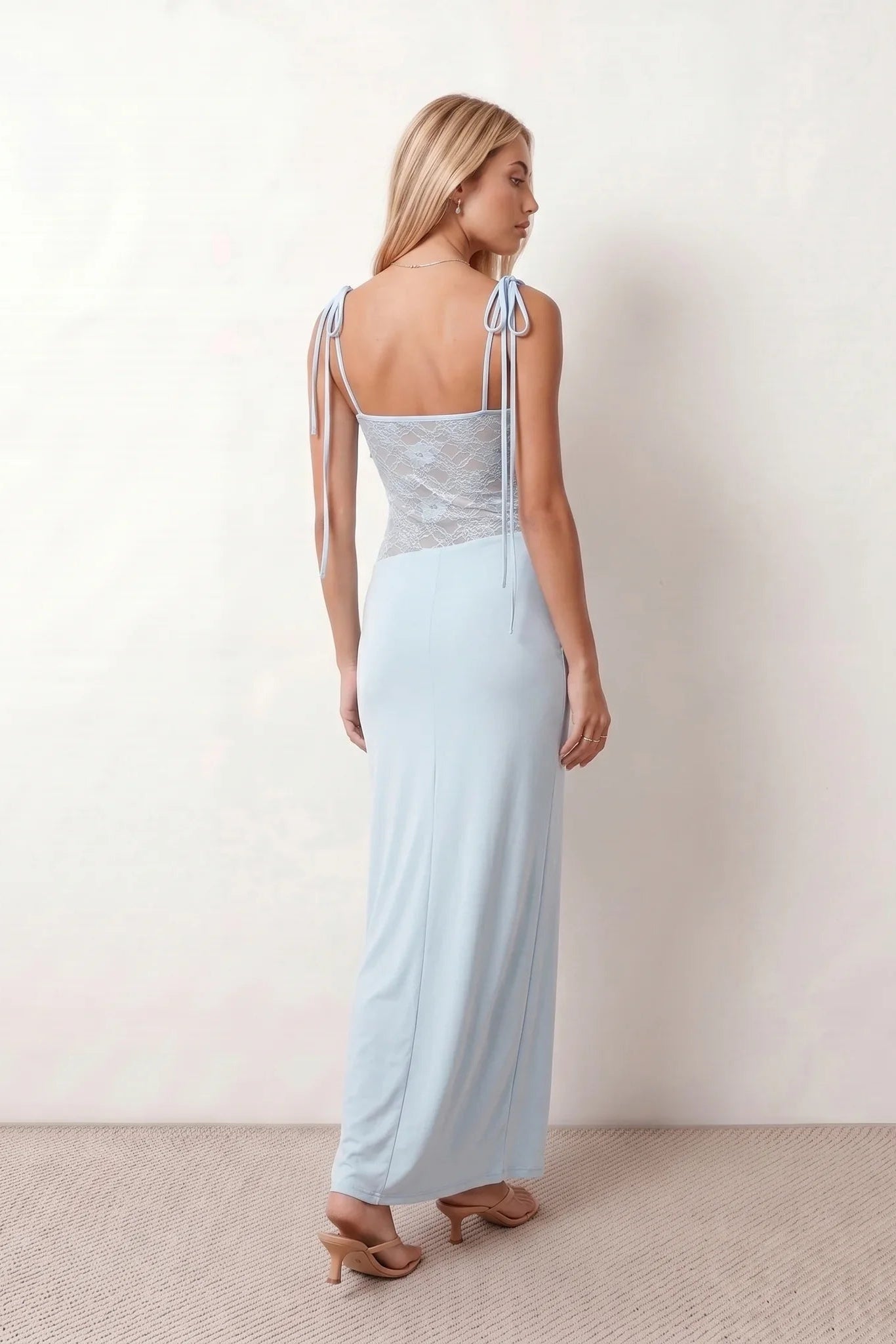 Women’s lace panel maxi dress featuring a square neckline, adjustable spaghetti straps, sheer lace waist, low open back, and floor-length silhouette for evening wear.