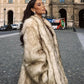 Women’s luxe faux fur coat featuring a plush textured finish and elegant silhouette for winter, evening, and special occasion styling.