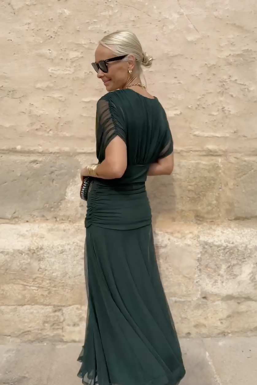 Women’s pleated V-neck maxi dress with flowing skirt and soft gradient tones