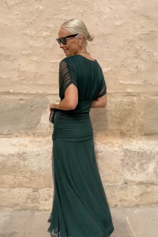 Women’s pleated V-neck maxi dress with flowing skirt and soft gradient tones