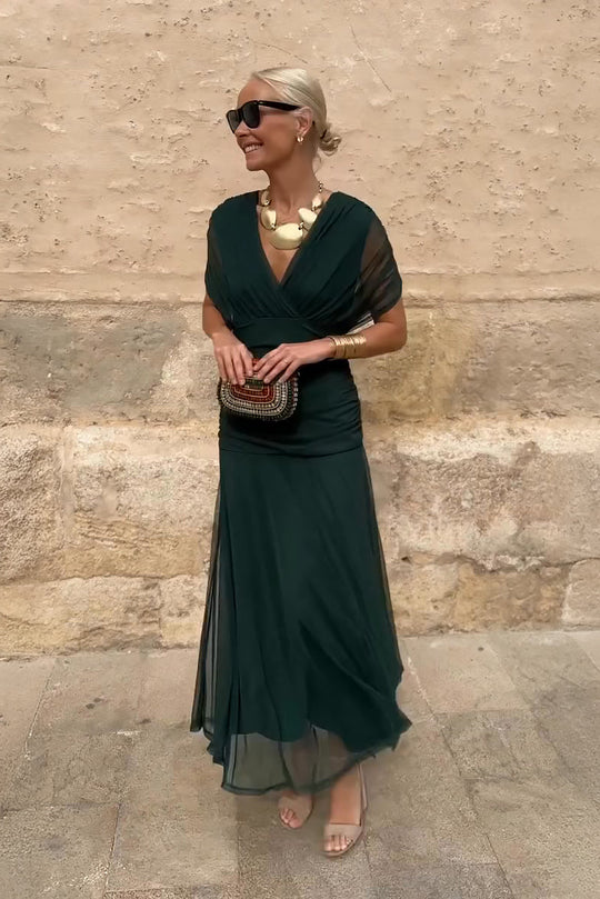 Women’s pleated V-neck maxi dress with flowing skirt and soft gradient tones