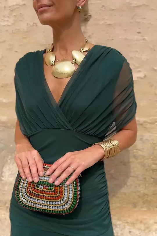 Women’s pleated V-neck maxi dress with flowing skirt and soft gradient tones