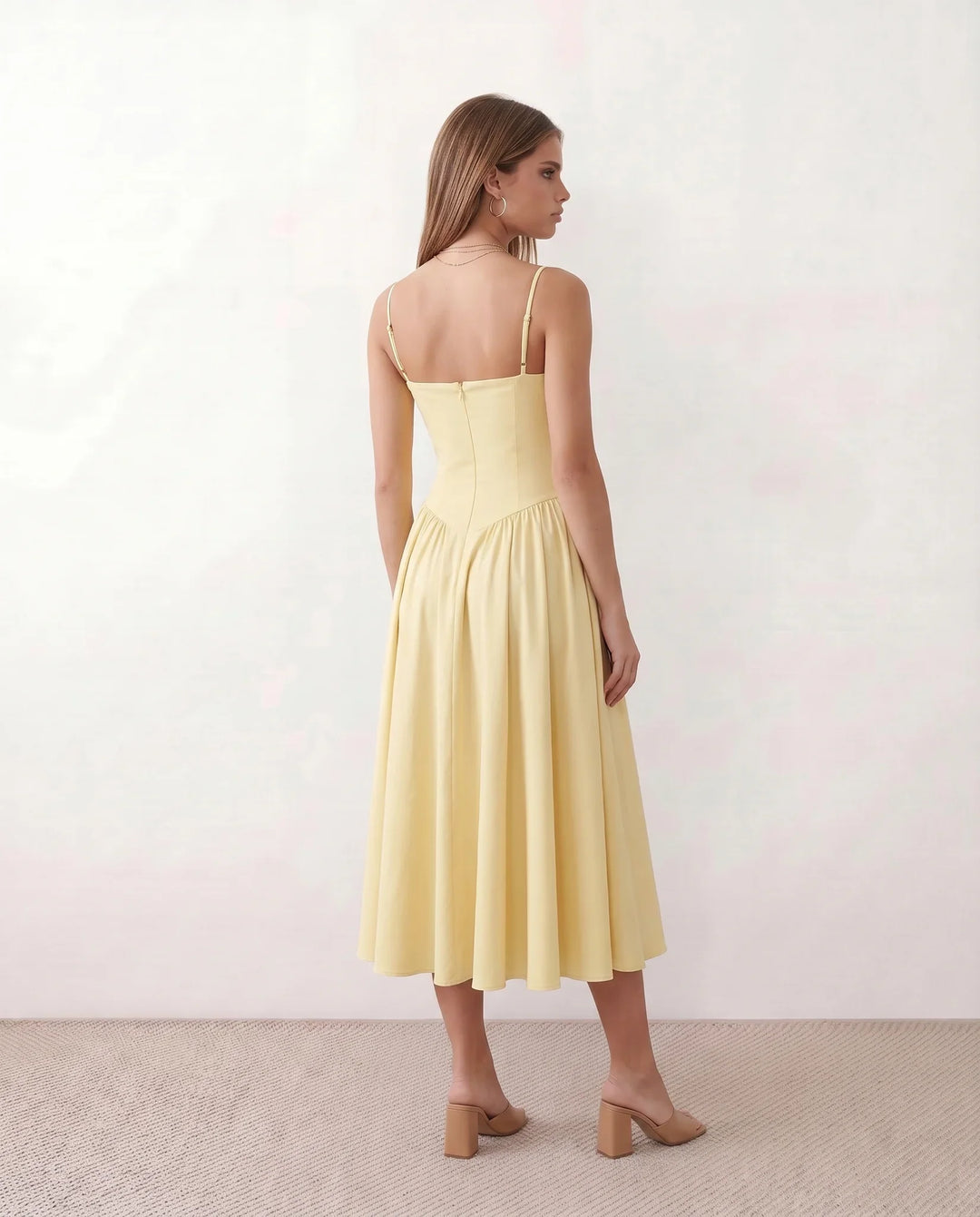 Women's sweetheart corset midi dress featuring a structured corset-inspired bodice, adjustable spaghetti straps, a defined waist, and a softly pleated A-line skirt. An elegant midi dress for weddings, cocktail parties, race days, and formal occasions.