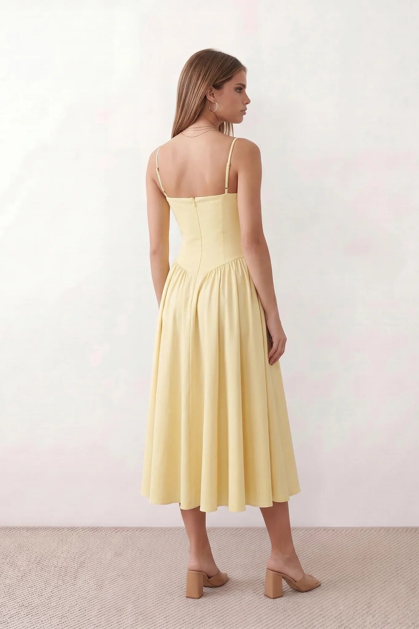 Women's sweetheart corset midi dress featuring a structured corset-inspired bodice, adjustable spaghetti straps, a defined waist, and a softly pleated A-line skirt. An elegant midi dress for weddings, cocktail parties, race days, and formal occasions.