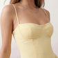 Women's sweetheart corset midi dress featuring a structured corset-inspired bodice, adjustable spaghetti straps, a defined waist, and a softly pleated A-line skirt. An elegant midi dress for weddings, cocktail parties, race days, and formal occasions.