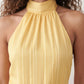 Bella Glossy Halter Mini Dress with a halter mock neckline, tie-back closure, smocked waist, open back, and tiered ruffle mini skirt in a glossy finish, available in Beige, Red, Purple, Yellow, Pink, and Light Blue.