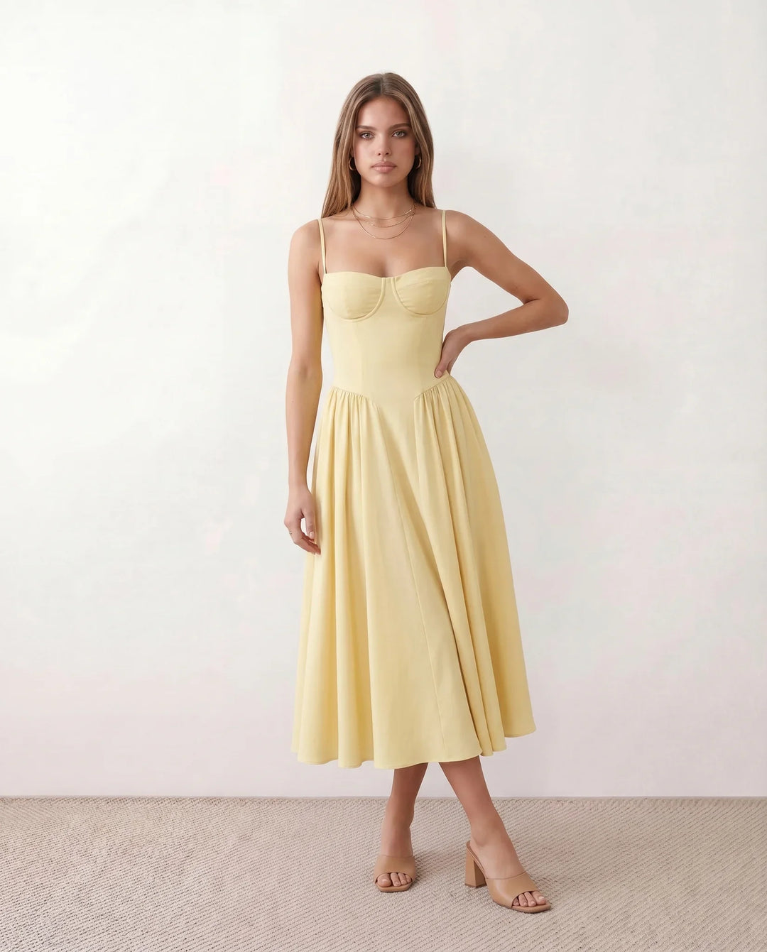 Women's sweetheart corset midi dress featuring a structured corset-inspired bodice, adjustable spaghetti straps, a defined waist, and a softly pleated A-line skirt. An elegant midi dress for weddings, cocktail parties, race days, and formal occasions.