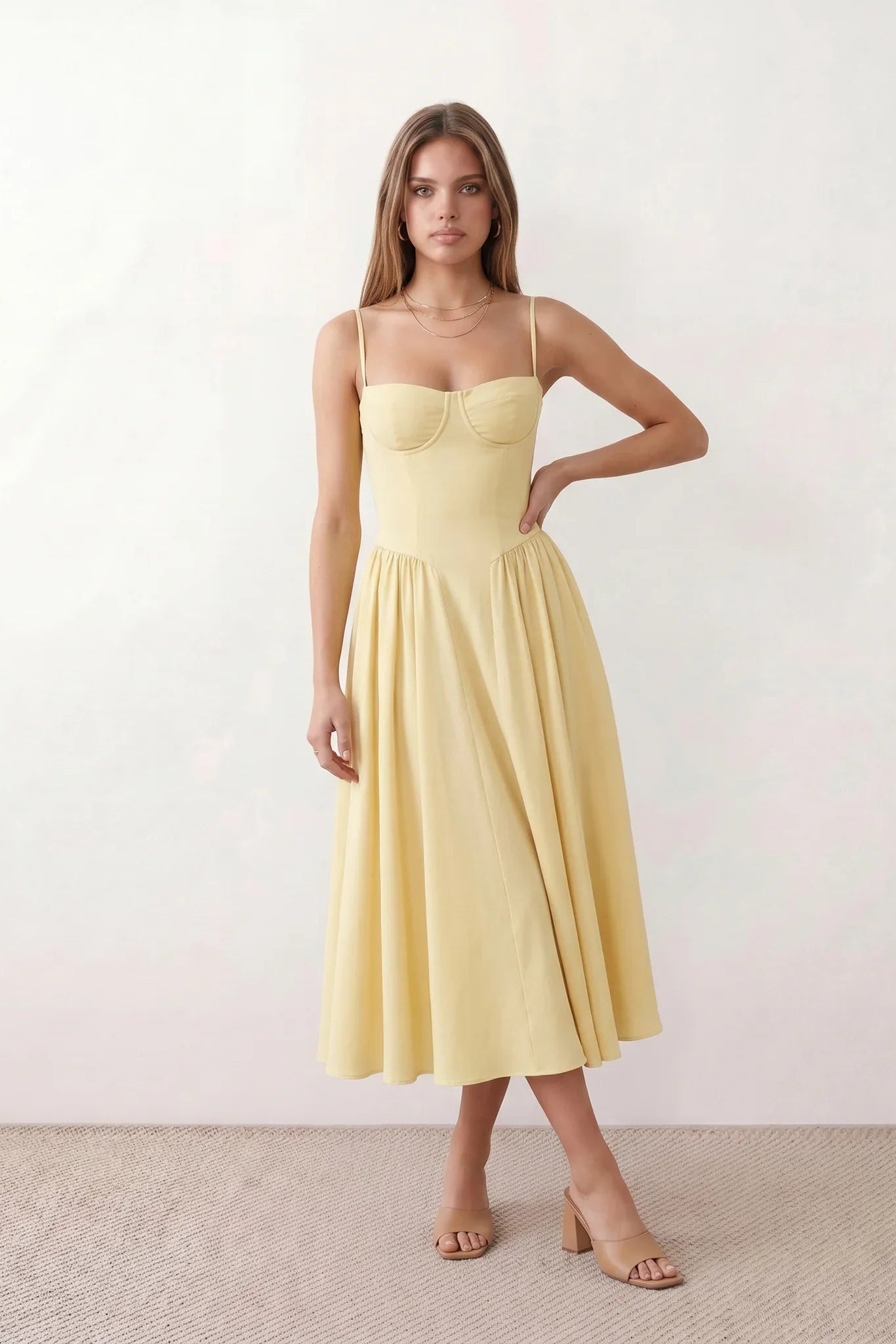 Women's sweetheart corset midi dress featuring a structured corset-inspired bodice, adjustable spaghetti straps, a defined waist, and a softly pleated A-line skirt. An elegant midi dress for weddings, cocktail parties, race days, and formal occasions.