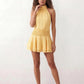 Bella Glossy Halter Mini Dress with a halter mock neckline, tie-back closure, smocked waist, open back, and tiered ruffle mini skirt in a glossy finish, available in Beige, Red, Purple, Yellow, Pink, and Light Blue.